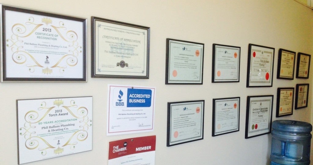 The wall of awards that line their office.